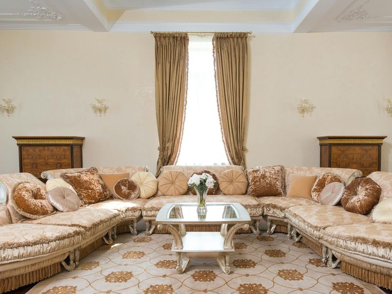 Spacious, empty room with sunlight streaming through a large window.